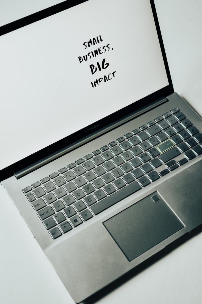 Mastering the First Impression: Your intriguing post title goes here A laptop screen with the text 'Small Business, Big Impact,' symbolizing modern entrepreneurship.